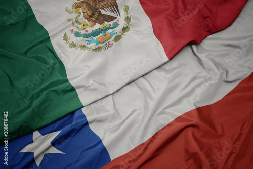 waving colorful flag of chile and national flag of mexico.