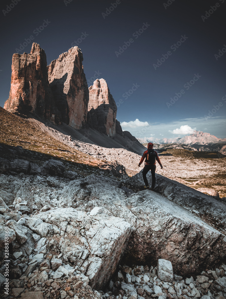 Backpacker on trip aound Tre Cime di Lavaredo. View from tour around popular massive, Dolomite Alps, Italy