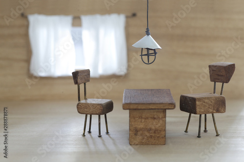 Fototapeta Naklejka Na Ścianę i Meble -  小さな椅子とテーブルとライトと窓のミニチュアジオラマ風インテリア