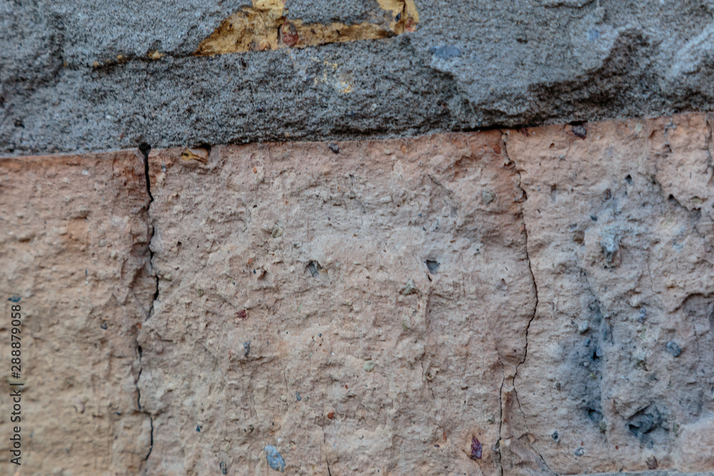A rock. Brick wall. Background. Close-up. A rock. Brick wall. Background. Close-up.