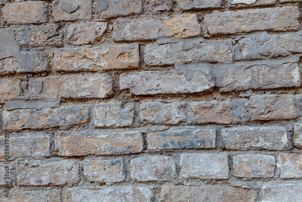 A rock. Brick wall. Background. Close-up. A rock. Brick wall. Background. Close-up.