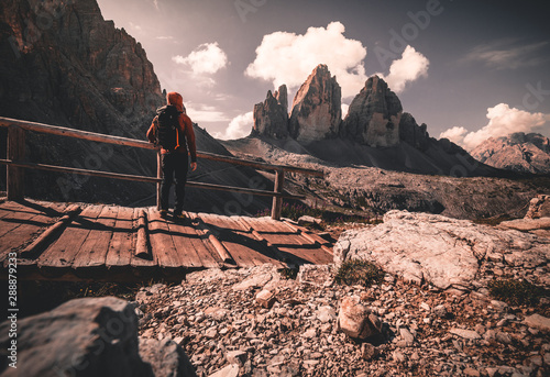 Backpacker on trip aound Tre Cime di Lavaredo. View from tour around popular massive, Dolomite Alps, Italy photo