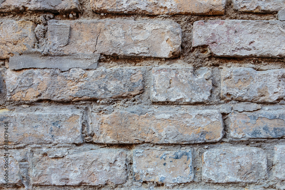 A rock. Brick wall. Background. Close-up. A rock. Brick wall. Background. Close-up.