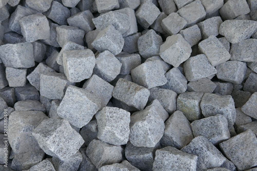Granite stones for natural stone paving in the building materials trade for sale, close-up Granite stones for natural stone paving in the building materials trade for sale, close-up