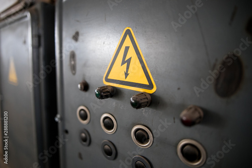 Schilderij op canvas Danger of electrocution yellow sign on gray background