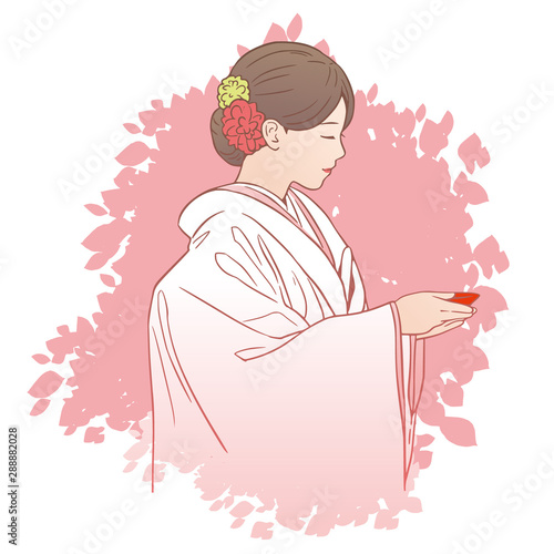 三献の儀（三々九度）で盃を手にする花嫁