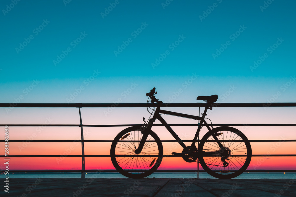 Morning Ride: Silhouetted Bicycle on the Beach at Dawn
