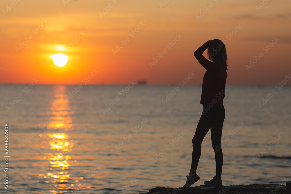 Sunrise Harmony: Silhouetted Woman in Peaceful Reverie