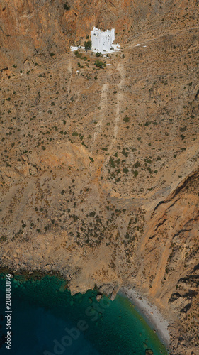 Aerial drone photo of breathtaking whitewashed holy Monastery of Panagia Hozoviotissa built in a steep cliff overlooking the Aegean deep blue sea, Amorgos island, Cyclades, Greece photo