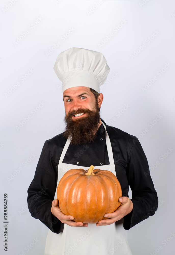 Chef preparing meal in kitchen. Autumn vegetables. Big pumpkin for Halloween. Fresh Pumpkin. Harvest pumpkin. Bearded cook in chef hat with pumpkin. Diet food. Healthy vegetarian eating. Farm market. Chef preparing meal in kitchen. Autumn vegetables. Big pumpkin for Halloween. Fresh Pumpkin. Harvest pumpkin. Bearded cook in chef hat with pumpkin. Diet food. Healthy vegetarian eating. Farm market.