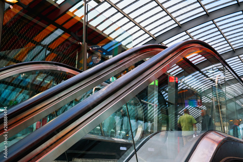 escalator up at the station, glass, urban environment, shopping center.