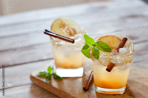 Apple cider cocktail with cinnamon and apple traditional autumn and winter drink