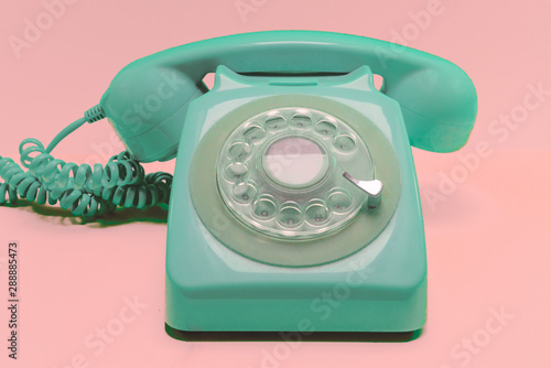 Mint Colored Retro Style Rotary Phone on Pink Background