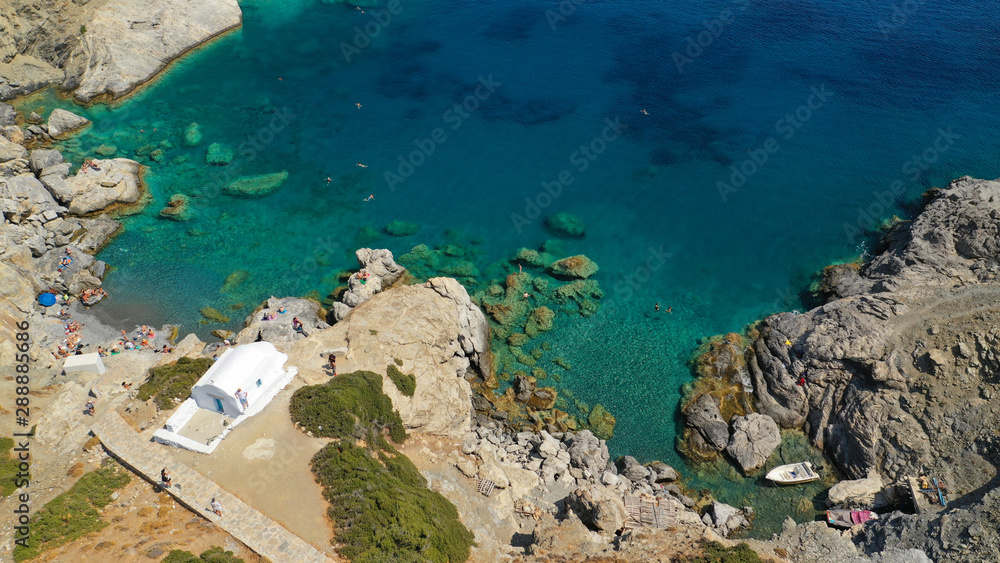 Aerial drone photo of iconic small chapel of Agia Anna built just above emerald rocky pebble beach, Amorgos island, Cyclades, Greece