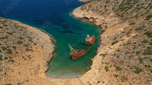 Aerial drone photo of old abandoned rusty shipwreck near area of Kalotaritissa, Amorgos island, Cyclades, Greece photo