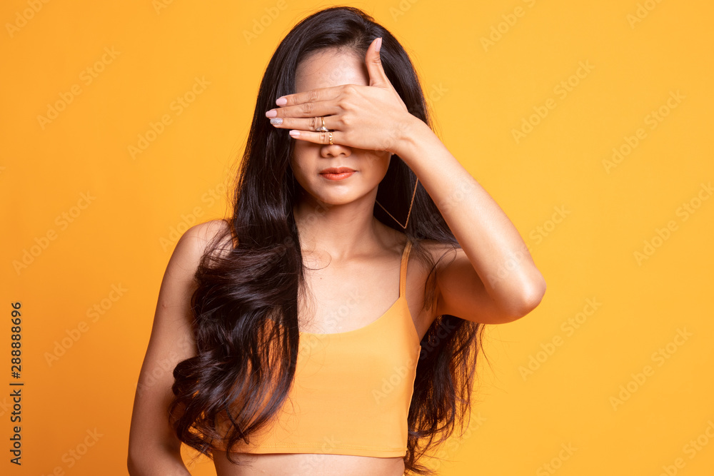 Young Asian woman close her eyes with hand. Young Asian woman close her eyes with hand.
