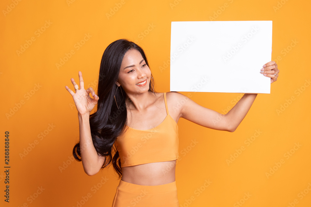 Young Asian woman show OK with white blank sign. Young Asian woman show OK with white blank sign.