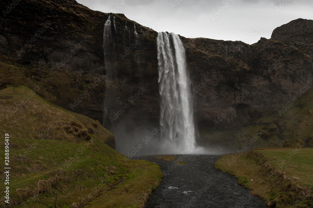 Famous Iceland waterfalls with a clean water on a stony rocky mountain landscape