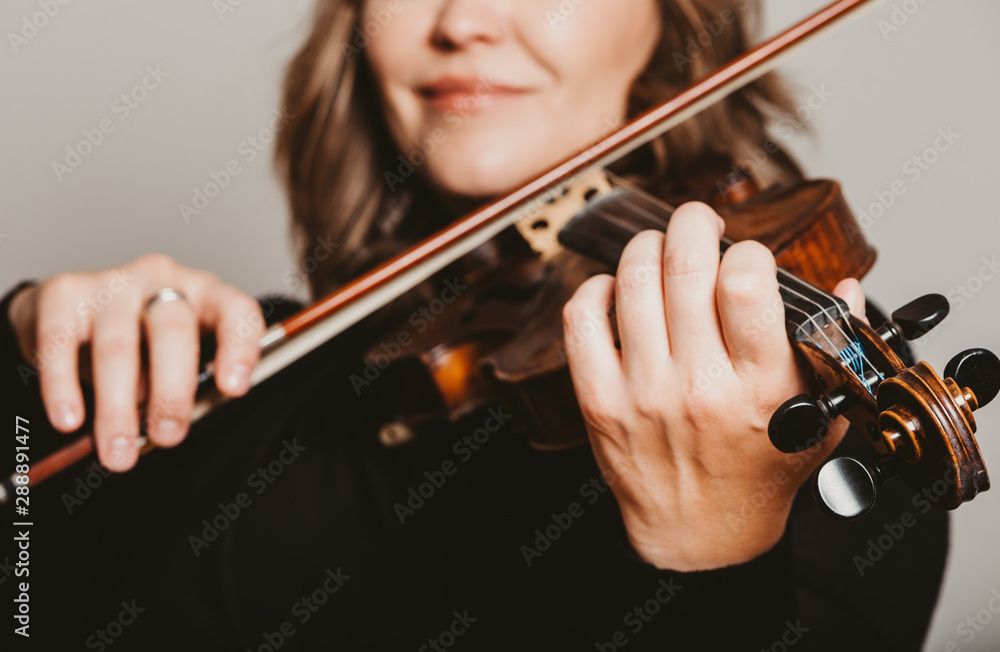 Studio close up portrait of beautiful woman with violin, white background Studio close up portrait of beautiful woman with violin, white background