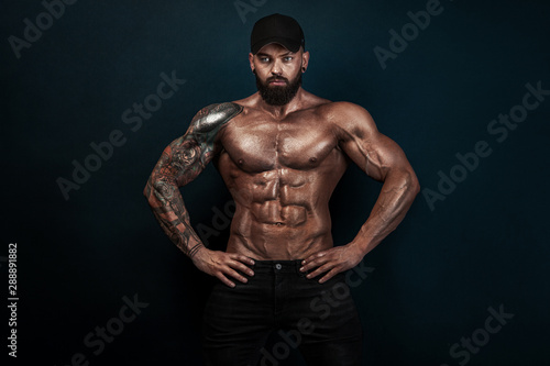 Strong and fit man bodybuilder. Sporty muscular guy athlete. Sport and fitness concept. Men's fashion.