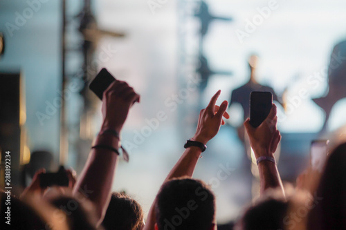 crowd of people having fun at concert - summer music festival