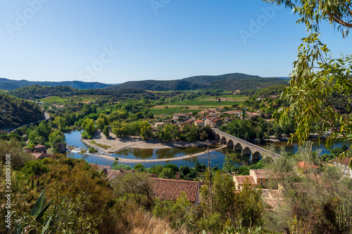 The bend and bridge on the river Orb at Roquebrun  in the Haut Languedoc, France photo