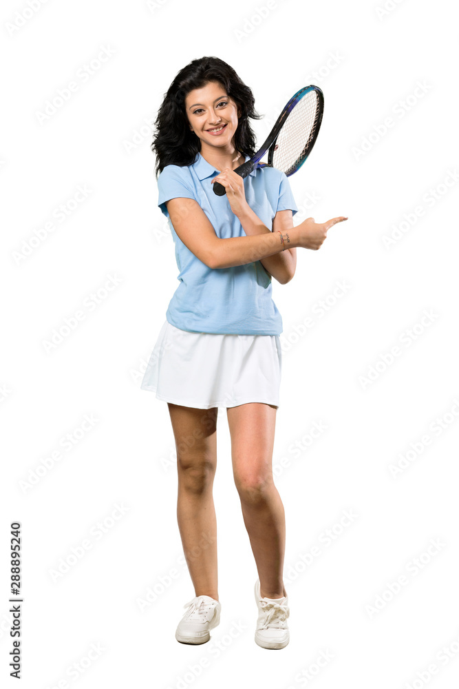 A full-length shot of a Young tennis player woman pointing to the side to present a product over isolated white background