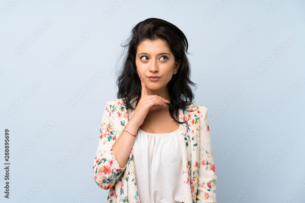 Young woman over isolated blue background thinking an idea Young woman over isolated blue background thinking an idea