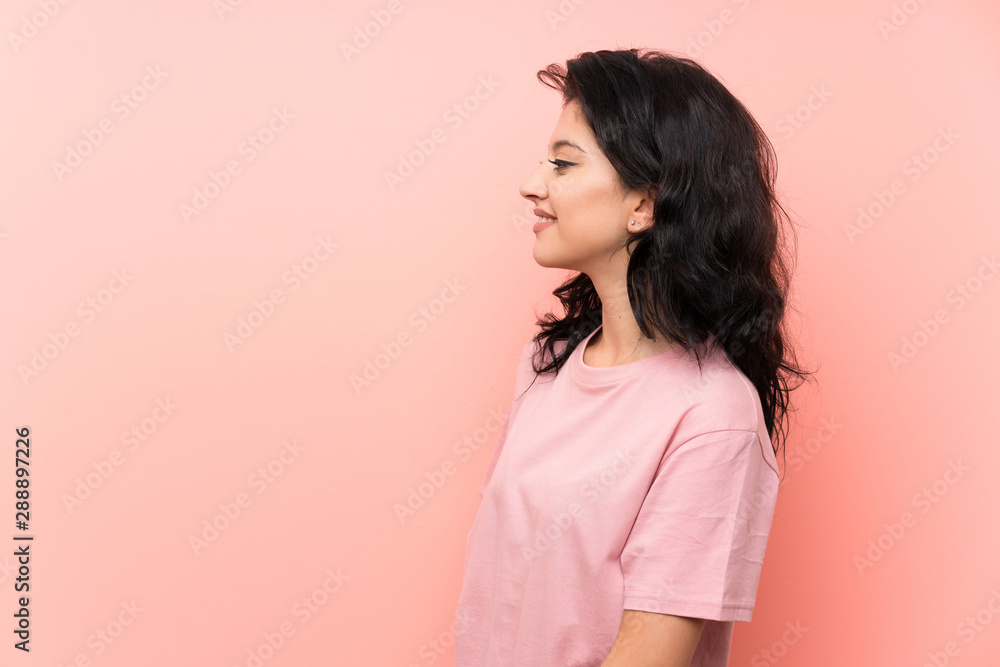 Young woman over isolated pink background looking to the side Young woman over isolated pink background looking to the side