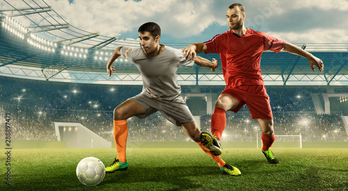 Soccer players fight for a ball. Tough game. Professional sports arena © TandemBranding