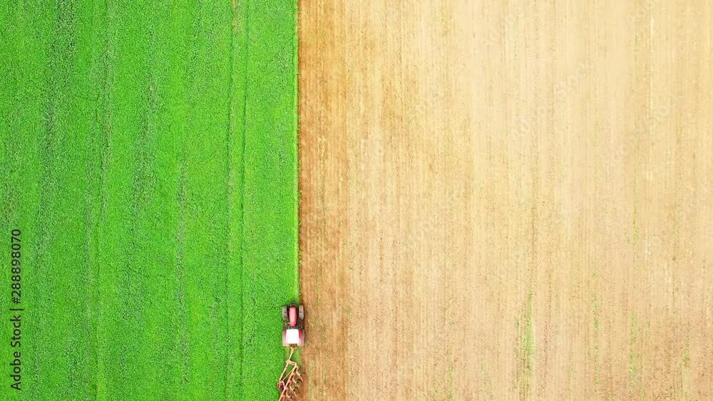 Tractor with plough working on a field. Farmer use green manure for organic growing. Agriculture from above. Environmentally friendly farming. Tractor with plough working on a field. Farmer use green manure for organic growing. Agriculture from above. Environmentally friendly farming.
