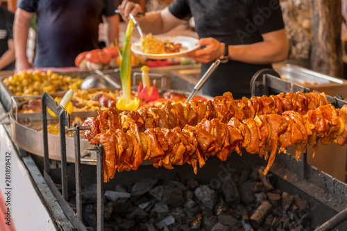 Grilled shashlik is prepared in a market. Concept: food on vacation
