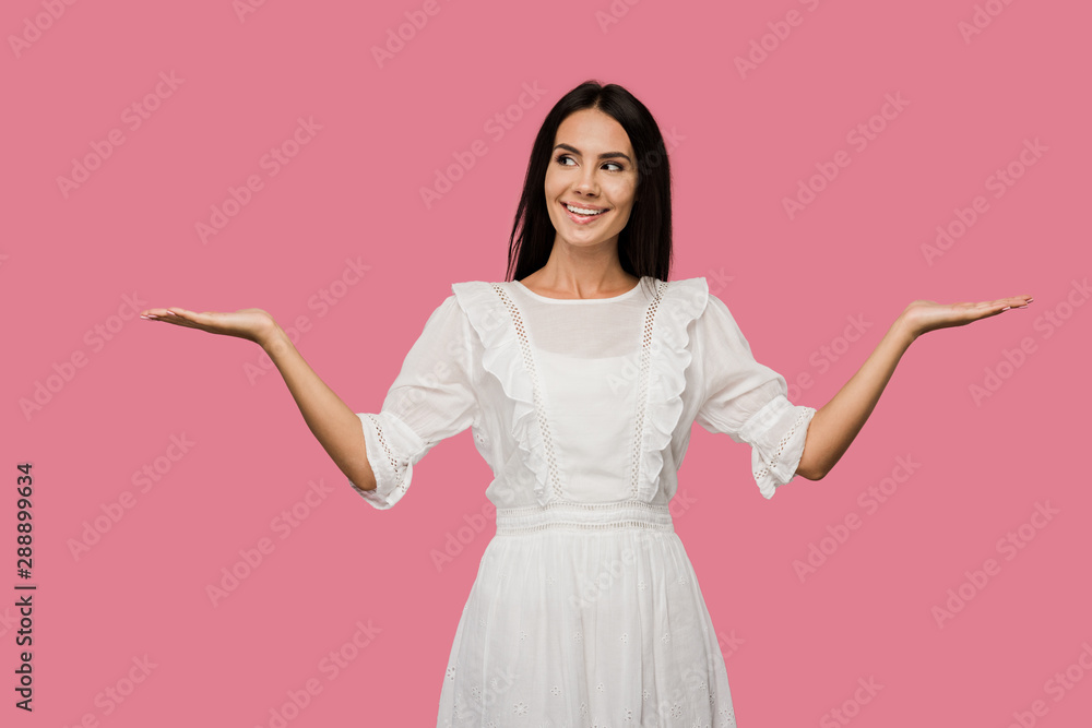 cheerful young woman in white dress gesturing isolated on pink cheerful young woman in white dress gesturing isolated on pink