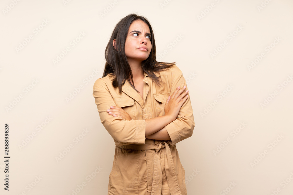 Young girl over isolated background making doubts gesture while lifting the shoulders Young girl over isolated background making doubts gesture while lifting the shoulders