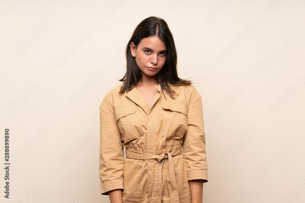 Young girl over isolated background with sad and depressed expression Young girl over isolated background with sad and depressed expression