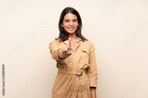 Young girl over isolated background showing and lifting a finger