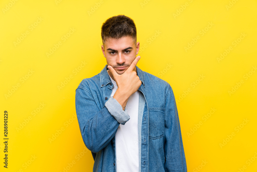Young handsome man over isolated yellow background thinking an idea Young handsome man over isolated yellow background thinking an idea