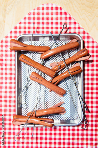 Skewered Hot Dogs on Red and White Picnic Blanket photo