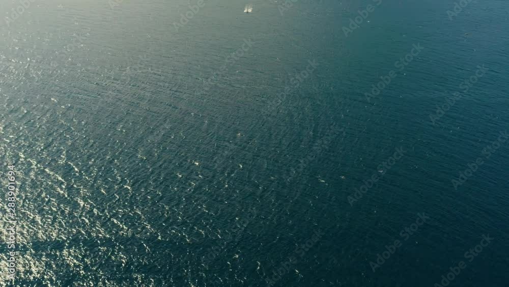 Philippine motor boat on the surface of the blue sea. top view. Traditional Filipino wooden outrigger boat called a banca. Philippines Philippine motor boat on the surface of the blue sea. top view. Traditional Filipino wooden outrigger boat called a banca. Philippines