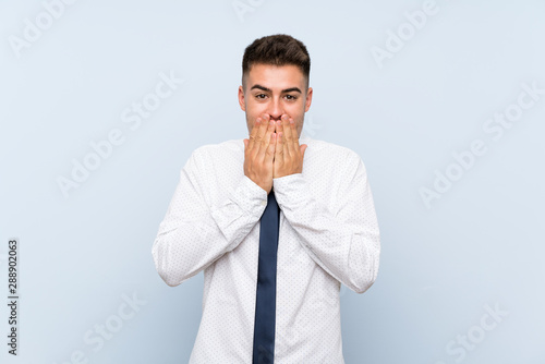 Handsome businessman over isolated blue background with surprise facial expression