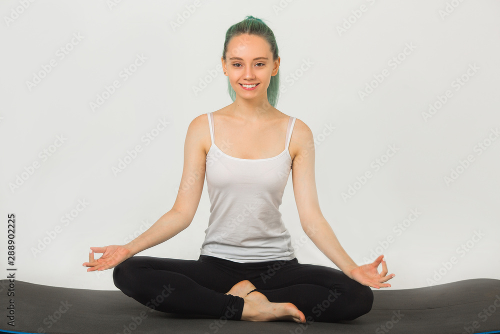 beautiful young woman doing gymnastics in yoga pose on a white background beautiful young woman doing gymnastics in yoga pose on a white background