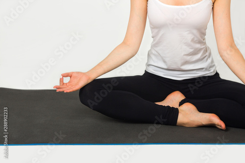 woman doing yoga in the studio on the mat