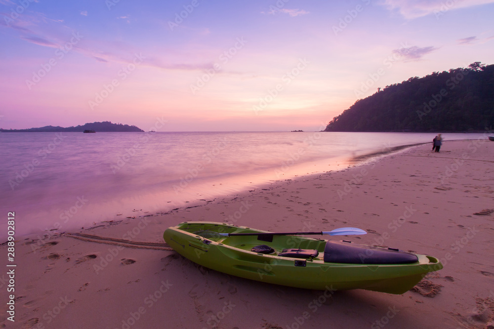 Kayaks on the tropical beach at twilight time , Thailand