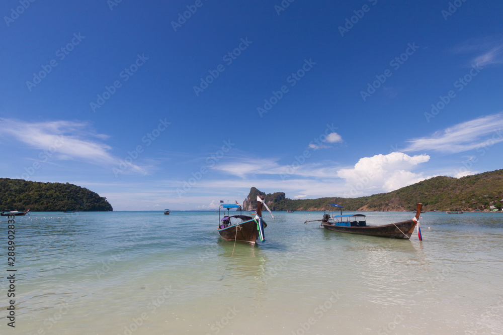 Traditional Thai boats on the beach at Phi Phi island , Thailand