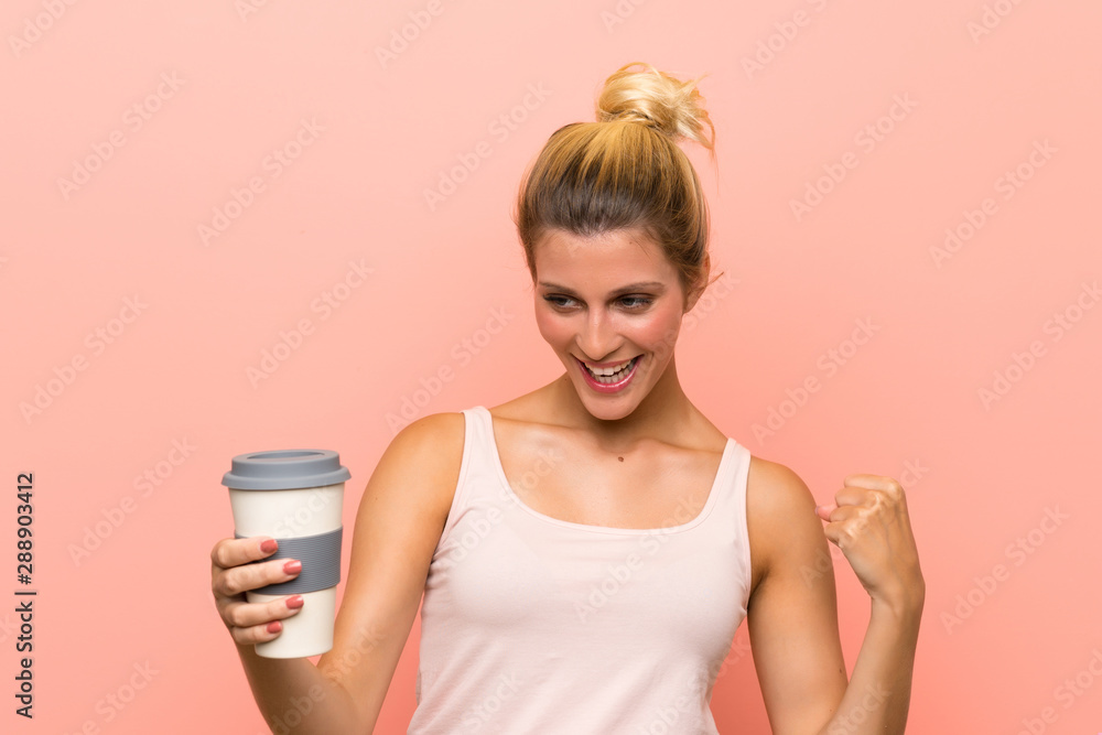 Young blonde woman holding a take away coffee celebrating a victory Young blonde woman holding a take away coffee celebrating a victory