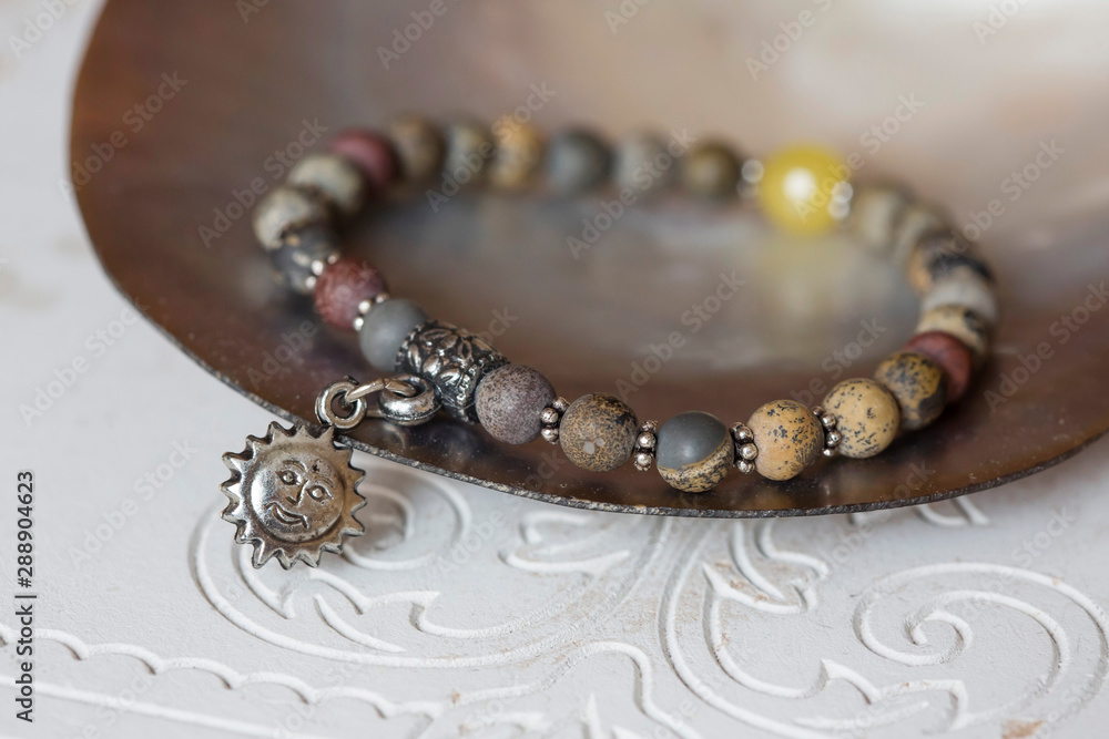 Mineral stone bracelet on natural neutral decorative background Mineral stone bracelet on natural neutral decorative background