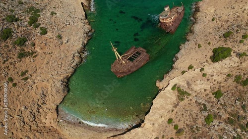 Aerial drone video of old abandoned rusty shipwreck near area of Kalotaritissa, Amorgos island, Cyclades, Greece photo