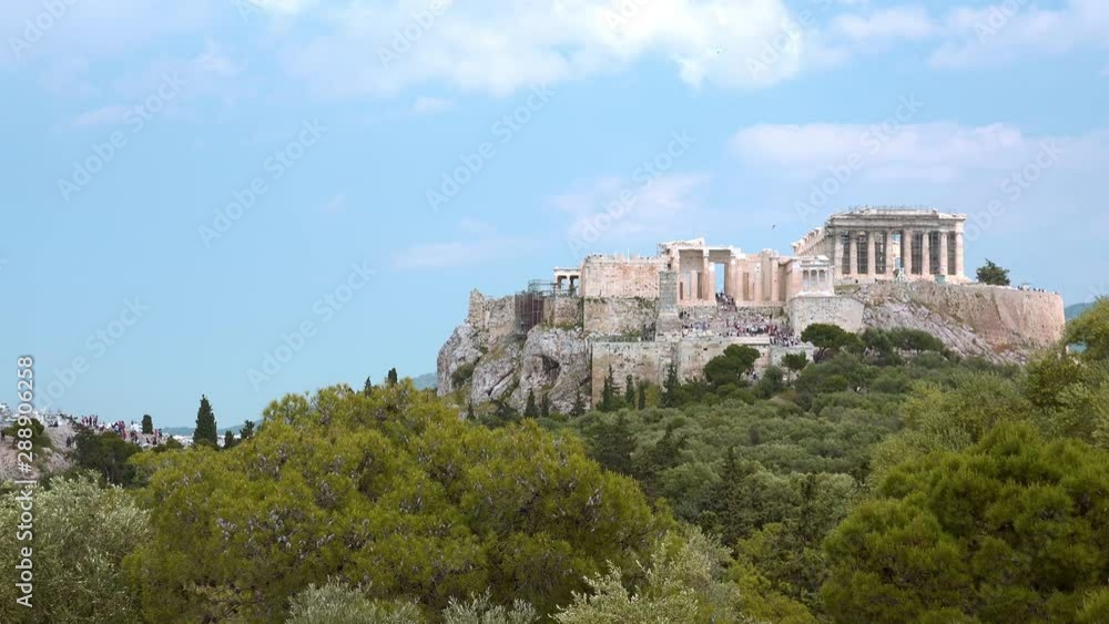 Amazing view of Athens at sunny day, Greece. Tourists walking around the Acropolis, ancient architecture ruins. Parthenon, the Icon of the hellenic civilization. Mount Lycabettus on background. Zoom Amazing view of Athens at sunny day, Greece. Tourists walking around the Acropolis, ancient architecture ruins. Parthenon, the Icon of the hellenic civilization. Mount Lycabettus on background. Zoom