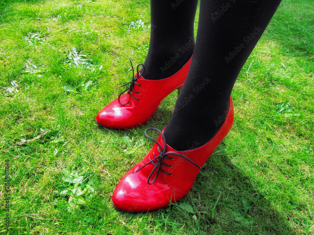 Red shoes at a garden party