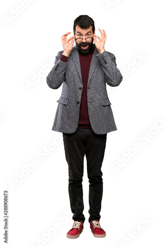 Handsome man with glasses with glasses and surprised over isolated white background